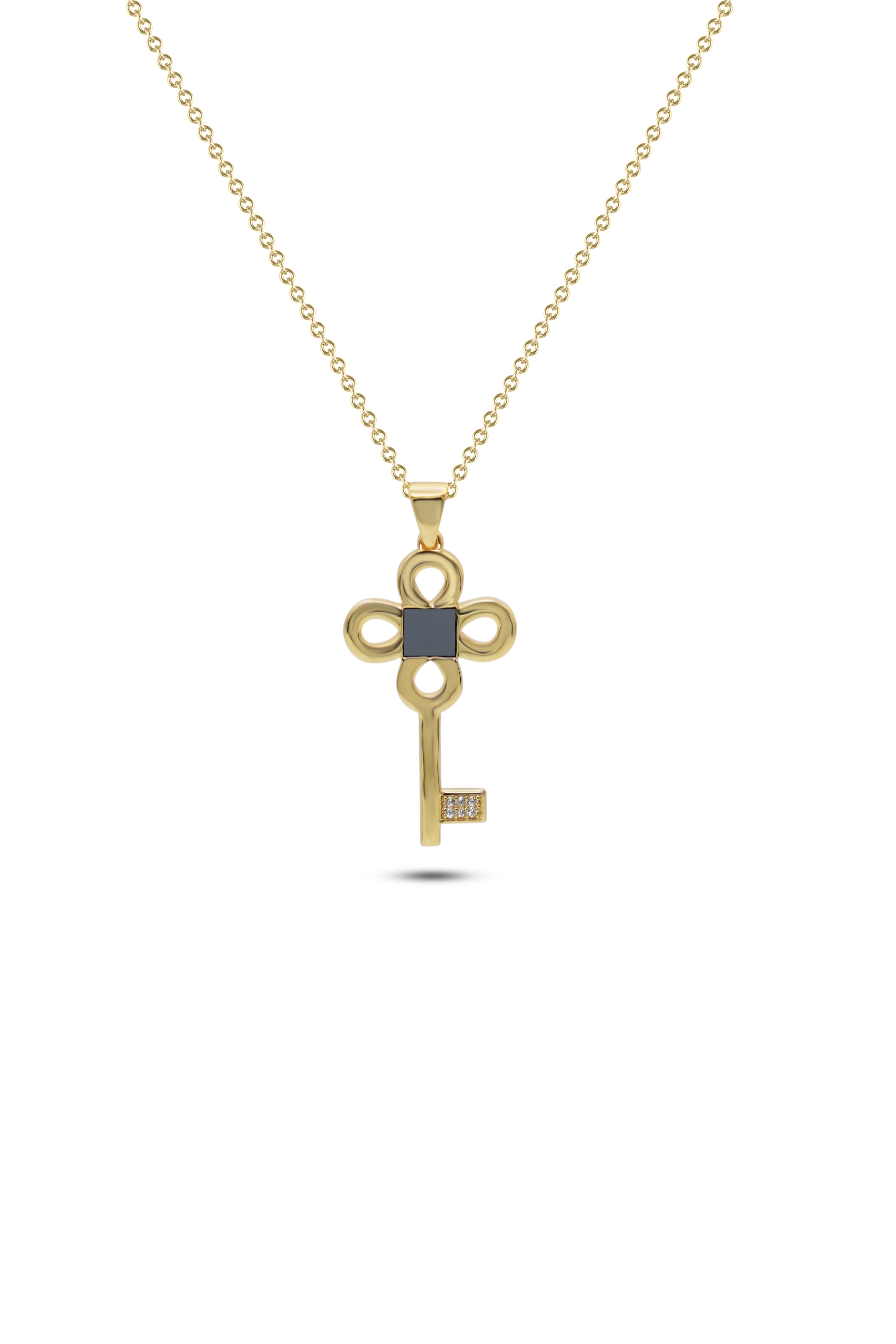 The Key Necklace- Old Testament Edition is a gold chain necklace with a key-shaped pendant featuring a black square center and small diamonds at the tip, styled by Nano Jewelry and shown on a white background.