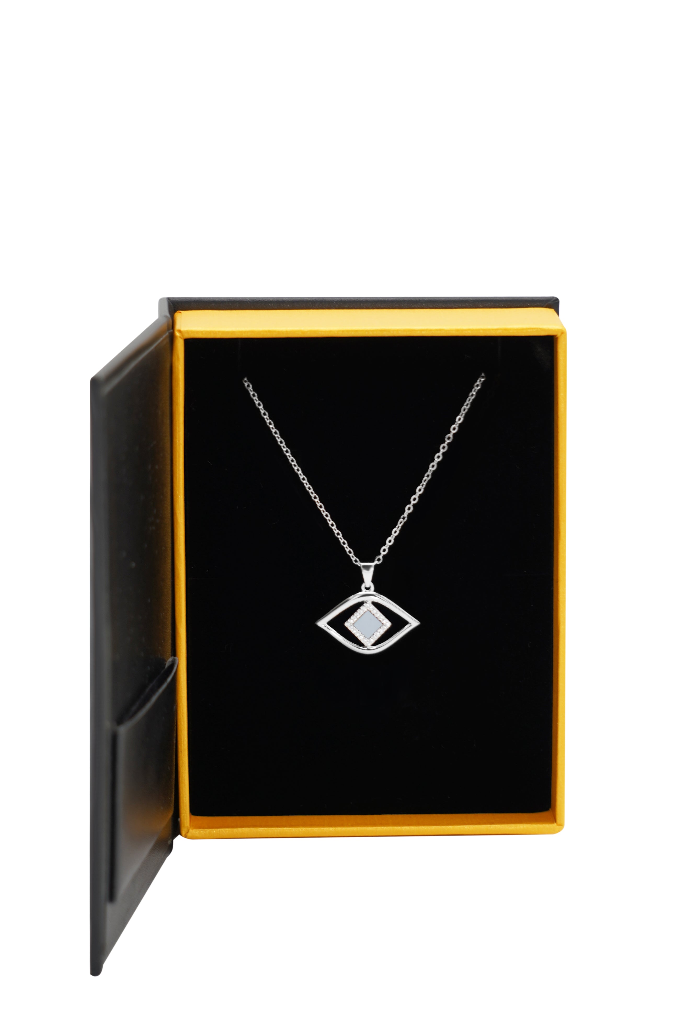 The Eye Necklace, a silver pendant in a geometric eye design ideal for modern nano jewelry, comes displayed in an open black and yellow jewelry box.