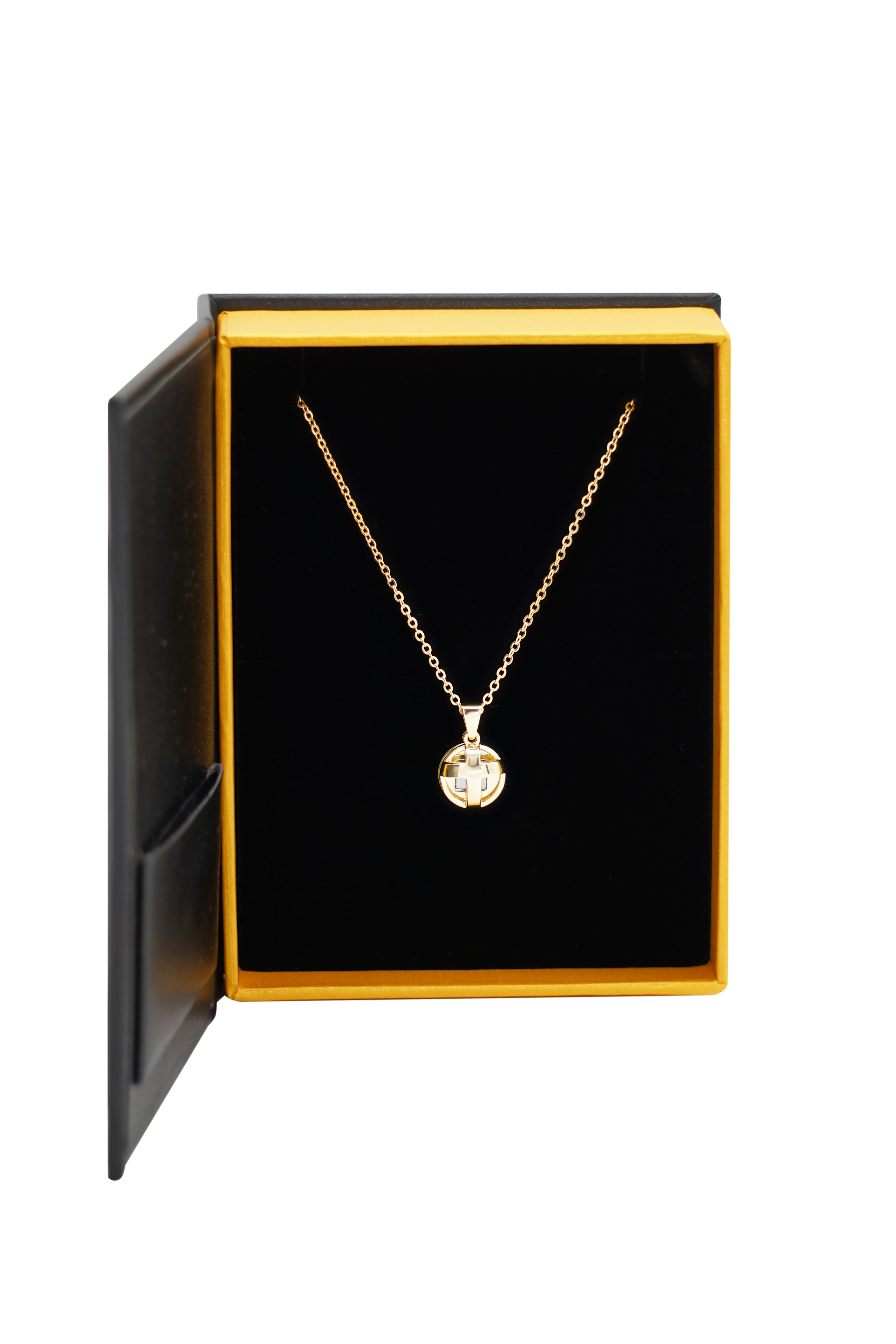 The Opening Cross gold necklace by Nano Jewelry features a round cross pendant, presented in a black and gold box with a black velvet interior.