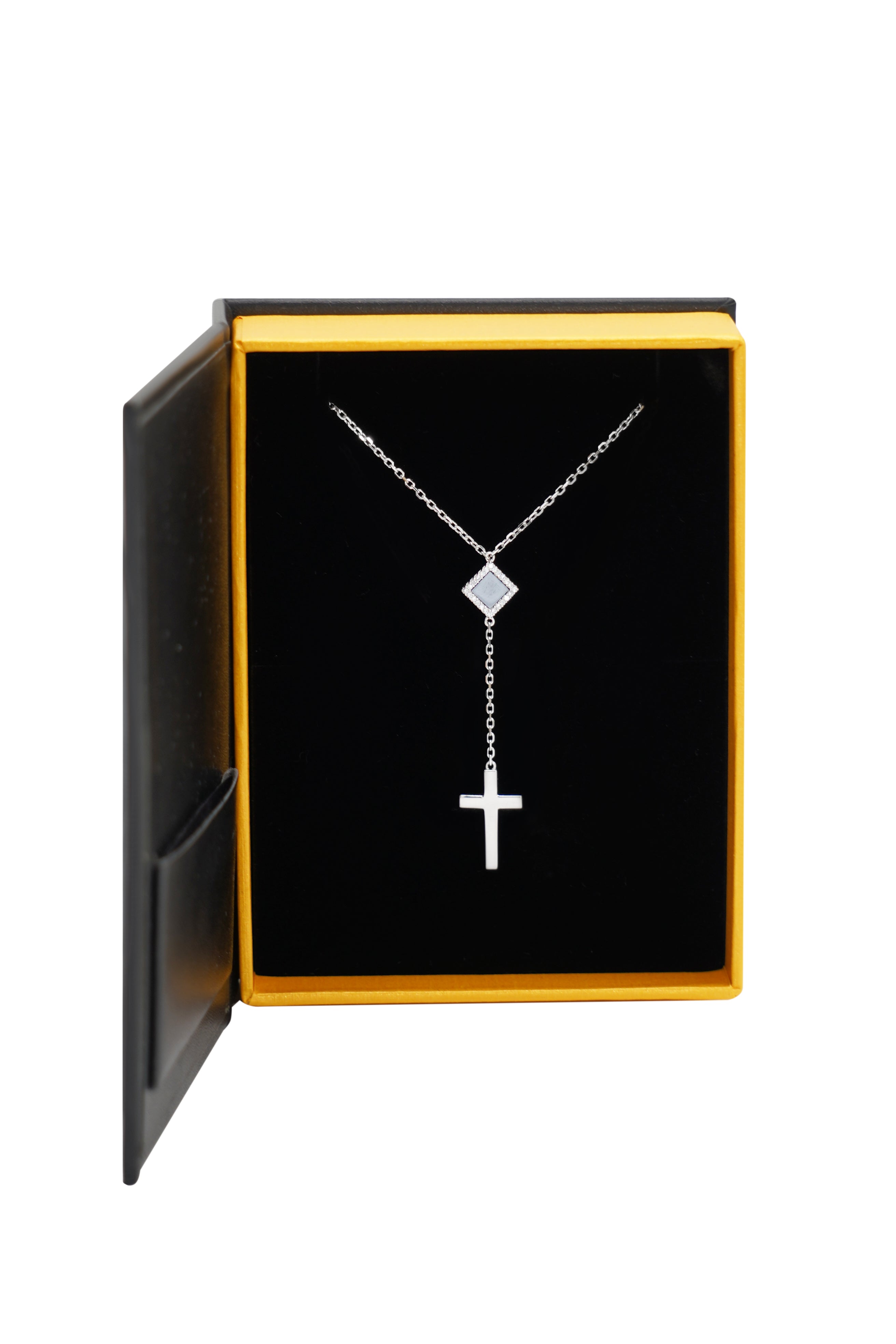 The Mini Cross Y Necklace, from our Christian Jewelry collection, is shown in an open black and yellow jewelry box against a white background.