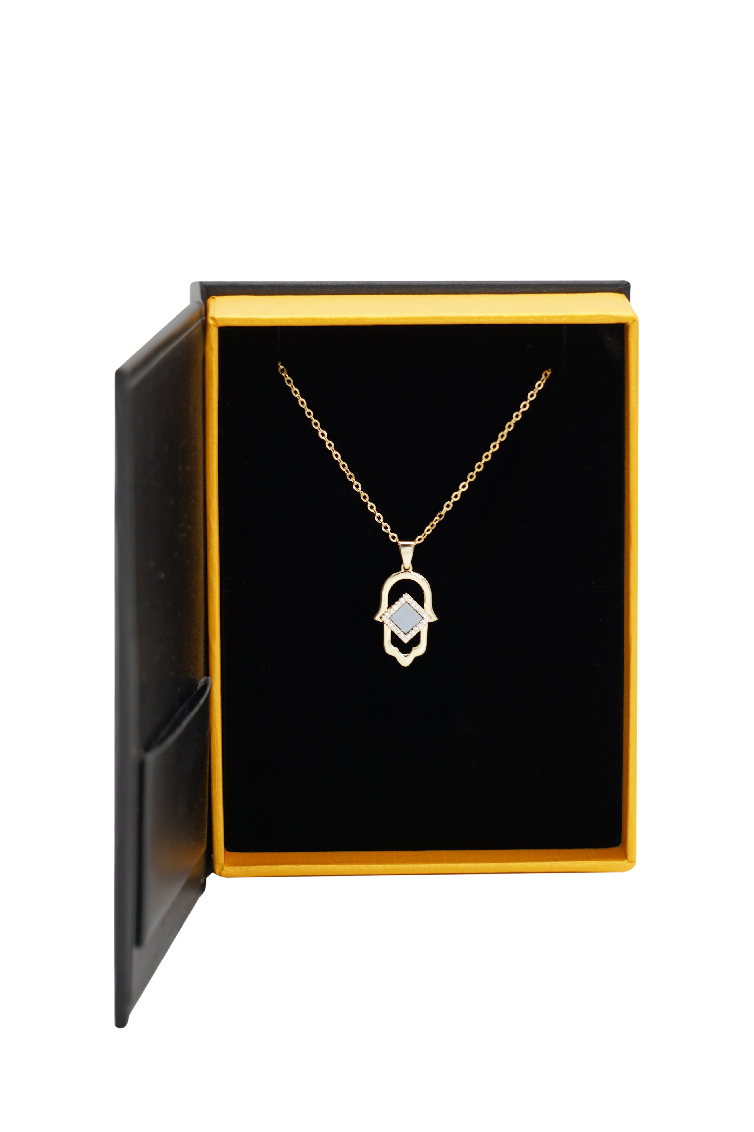 Hamsa Necklace | Old Testament Edition from NanoBless, featuring a geometric pendant, displayed in an open black and gold jewelry box against a plain white background.